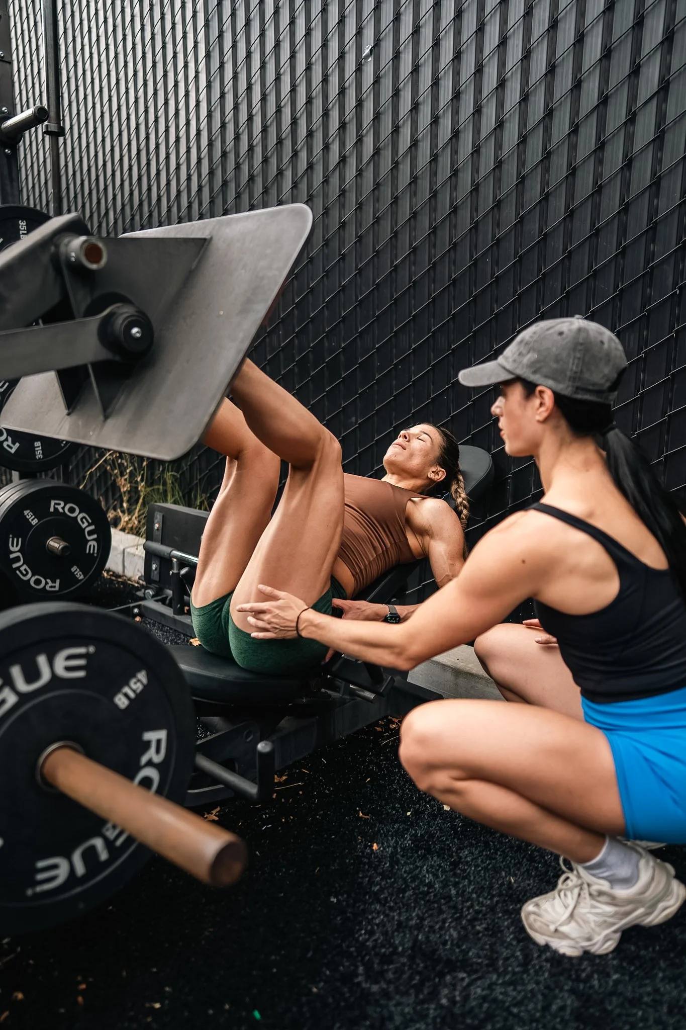 Erika coaching a client on the leg press at The Lab Gym in San Ramon