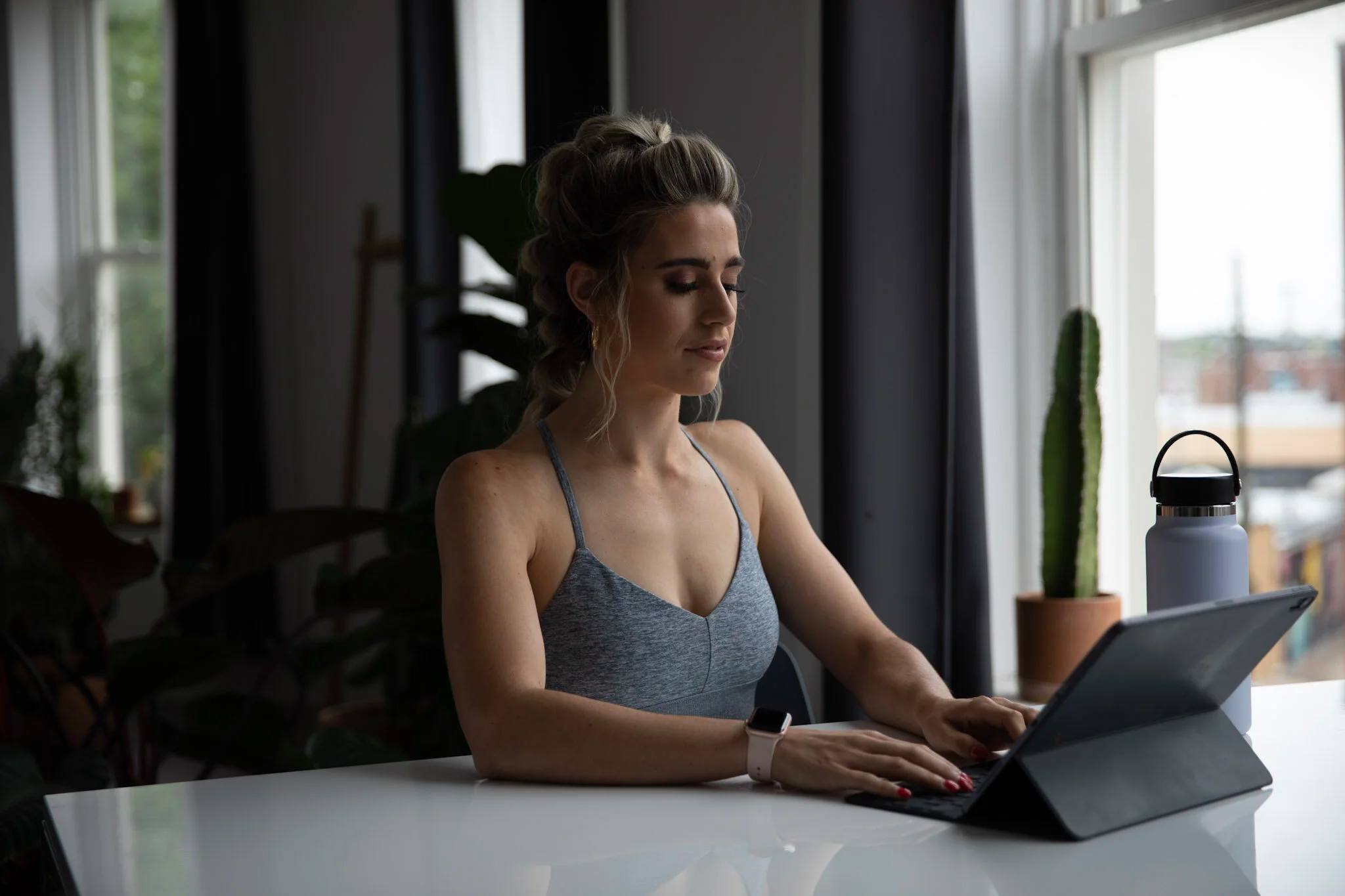 Erika reviewing a client's online check-in on her iPad