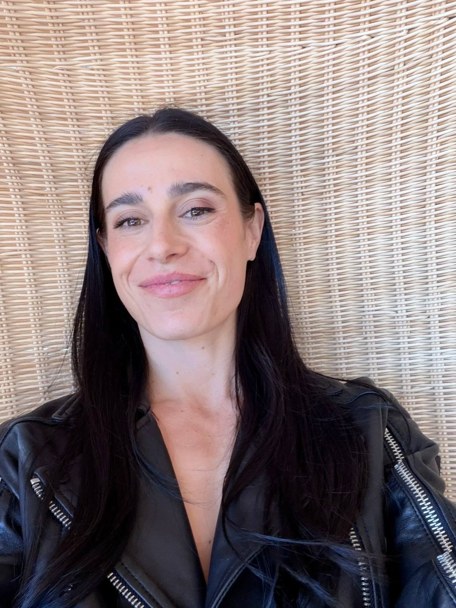 Erika Vig smiling, in a black leather jacket